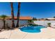 Inviting backyard pool features a rock waterfall, lush palm trees, and ample space for entertaining at 5125 W Wickiup Ln, Glendale, AZ 85308