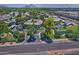 Expansive aerial view of Cloisters Condominiums with lush landscaping, pond, and Camelback Mountain in the background at 5203 N 24Th St # 207, Phoenix, AZ 85016