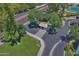 Aerial view showcases a guard house with green landscaping, palm trees, and proximity to a street at 5203 N 24Th St # 207, Phoenix, AZ 85016