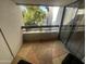 Relaxing balcony with beautiful tile floors and sliding glass doors with a view of trees at 5203 N 24Th St # 207, Phoenix, AZ 85016