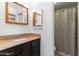 Bathroom featuring granite countertops, dark wood cabinets, and a shower-tub combination with a shower curtain at 5203 N 24Th St # 207, Phoenix, AZ 85016