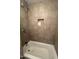 Relaxing bathroom including tiled shower and a tub with toiletry shelf at 5203 N 24Th St # 207, Phoenix, AZ 85016