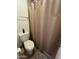 Cozy bathroom showcasing toilet and neutral shower curtain for added privacy at 5203 N 24Th St # 207, Phoenix, AZ 85016