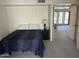 Cozy bedroom featuring a comfortable bed, bedside table, and an open doorway at 5203 N 24Th St # 207, Phoenix, AZ 85016