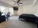 Bedroom featuring carpet, a ceiling fan, a black bedspread, and a window with blinds at 5203 N 24Th St # 207, Phoenix, AZ 85016
