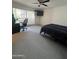 Bedroom with a ceiling fan, carpet, a window with blinds, and a black bedspread at 5203 N 24Th St # 207, Phoenix, AZ 85016