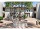 A charming courtyard with a fountain, lush greenery, and access to upper-level units at 5203 N 24Th St # 207, Phoenix, AZ 85016