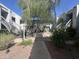 Beautiful courtyard with a fountain, mature trees, and access to units via outdoor staircases at 5203 N 24Th St # 207, Phoenix, AZ 85016