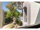 Scenic view from a balcony overlooking lush landscaping, a tranquil pond, and a sparkling community pool at 5203 N 24Th St # 207, Phoenix, AZ 85016