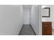 Hallway leading to the bathroom, featuring neutral walls, tiled floors, and a modern vanity at 5203 N 24Th St # 207, Phoenix, AZ 85016