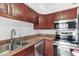 Well-equipped kitchen with stainless steel appliances, granite countertops, and ample dark wood cabinet space at 5203 N 24Th St # 207, Phoenix, AZ 85016