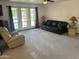 Spacious living room with ample seating, natural light from large windows, and neutral carpeting at 5203 N 24Th St # 207, Phoenix, AZ 85016