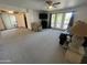 Spacious living room with ample seating, natural light from large windows, and neutral carpeting at 5203 N 24Th St # 207, Phoenix, AZ 85016
