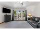 A bright living room with neutral tones, large windows, and a comfortable leather sofa at 5203 N 24Th St # 207, Phoenix, AZ 85016