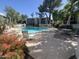 Sparkling community pool surrounded by lounge chairs, mature landscaping, shade trees, and outdoor seating at 5203 N 24Th St # 207, Phoenix, AZ 85016