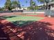 Well-maintained tennis courts offer a great amenity for active residents, with a red and green playing surface and mature trees at 5203 N 24Th St # 207, Phoenix, AZ 85016