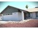 View of the home featuring a two-car garage, desert landscaping, and modern paint at 5529 W Zoe Ella Way, Glendale, AZ 85306