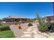 Desert landscaped backyard with stone accents, a covered patio, and views of neighboring properties at 6080 S Jojoba Ct, Gold Canyon, AZ 85118