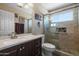Modern bathroom featuring a glass shower, vanity with a sink, and elegant tile finishes at 6080 S Jojoba Ct, Gold Canyon, AZ 85118
