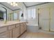 Well-lit bathroom offering a double vanity, a soaking tub, and a separate glass-enclosed shower at 6080 S Jojoba Ct, Gold Canyon, AZ 85118