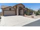 Charming single-story home with desert landscaping, a tile roof, and an attached garage at 6080 S Jojoba Ct, Gold Canyon, AZ 85118