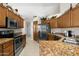 Spacious kitchen with stainless steel appliances, granite countertops, and ample cabinet space at 6080 S Jojoba Ct, Gold Canyon, AZ 85118