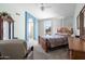 Tranquil main bedroom featuring a comfortable bed, light-filled windows, and seamless bathroom access at 6080 S Jojoba Ct, Gold Canyon, AZ 85118
