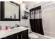 Bathroom with dark vanity and shower-tub combination at 6302 E Portia St, Mesa, AZ 85215