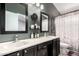 Modern bathroom features dual sinks, sleek black cabinets, and a shower/tub combo at 6302 E Portia St, Mesa, AZ 85215