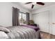 Bedroom featuring a ceiling fan, wood flooring, and closet at 6302 E Portia St, Mesa, AZ 85215