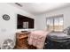 Bright bedroom with a large mounted flat screen TV and natural light at 6302 E Portia St, Mesa, AZ 85215