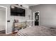 Stylish bedroom with a large wall-mounted TV and ensuite bathroom at 6302 E Portia St, Mesa, AZ 85215