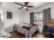 Bedroom featuring a ceiling fan, wood flooring, and natural light at 6302 E Portia St, Mesa, AZ 85215