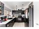 Modern kitchen features sleek black cabinetry, white countertops, and stainless steel appliances at 6302 E Portia St, Mesa, AZ 85215