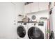 Laundry room with washer, dryer, and white cabinets at 6302 E Portia St, Mesa, AZ 85215
