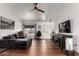 Spacious living room featuring wood floors, white walls, and large windows allowing plenty of natural light at 6302 E Portia St, Mesa, AZ 85215