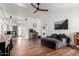 Bright living room featuring wood floors, a ceiling fan, and ample natural light at 6302 E Portia St, Mesa, AZ 85215