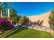 Inviting backyard seating area with artificial grass and lush, vibrant landscaping at 7821 N Via De La Sombre --, Scottsdale, AZ 85258