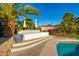 Luxurious backyard featuring a raised sunbed, lush landscaping, and a beautiful pool at 7821 N Via De La Sombre --, Scottsdale, AZ 85258