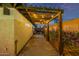 Exterior shot of the home featuring a pergola with string lights and flower lined wall at 7821 N Via De La Sombre --, Scottsdale, AZ 85258