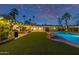 Beautiful backyard featuring a pool, patio area, string lights, and lush green turf at 7821 N Via De La Sombre --, Scottsdale, AZ 85258