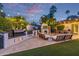 Outdoor kitchen with grill, TV, fireplace, and seating create a relaxing backyard retreat at 7821 N Via De La Sombre --, Scottsdale, AZ 85258