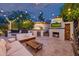 Resort style backyard with outdoor kitchen, fireplace, TV, and comfortable lounge seating at 7821 N Via De La Sombre --, Scottsdale, AZ 85258