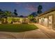 Outdoor living space with a built-in grill, fireplace, outdoor TV, and lush landscaping at 7821 N Via De La Sombre --, Scottsdale, AZ 85258