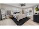 Bright bedroom with modern ceiling fan, wood floors, black accents, and large glass doors to closet at 7821 N Via De La Sombre --, Scottsdale, AZ 85258