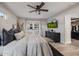 Bright bedroom with ceiling fan, wood floors, black accents, and large glass doors to walk-in closet at 7821 N Via De La Sombre --, Scottsdale, AZ 85258