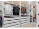 Custom walk-in closet featuring custom shelves, drawers, storage baskets, and clothing racks at 7821 N Via De La Sombre --, Scottsdale, AZ 85258