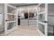 Large walk-in closet featuring custom shelves, drawers, storage baskets, and clothing racks behind french doors at 7821 N Via De La Sombre --, Scottsdale, AZ 85258