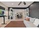 Open living area featuring a sofa, dark accent wall, and view into the kitchen at 7821 N Via De La Sombre --, Scottsdale, AZ 85258