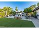 Outdoor kitchen, fireplace, and dining space surrounded by lush landscaping at 7821 N Via De La Sombre --, Scottsdale, AZ 85258